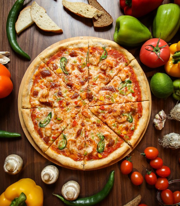 mixed pizza0 with various ingridients on the table top view